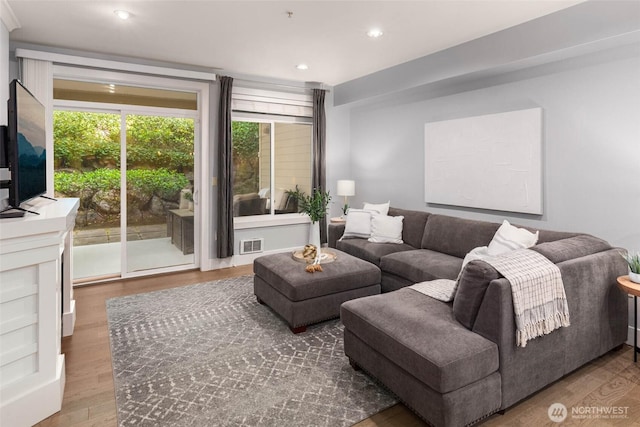 living area featuring wood finished floors and recessed lighting