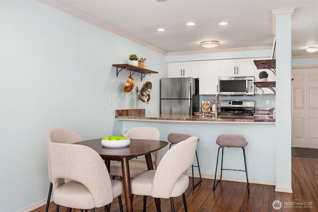 kitchen featuring appliances with stainless steel finishes, open shelves, ornamental molding, wood finished floors, and white cabinets