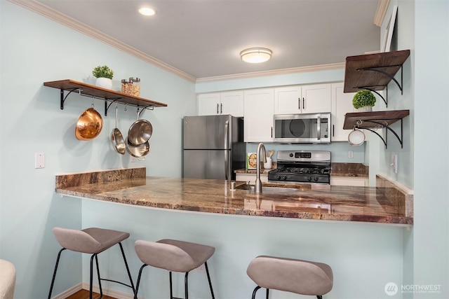 kitchen with open shelves, appliances with stainless steel finishes, a sink, a peninsula, and ornamental molding