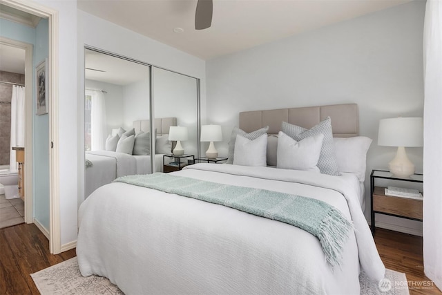bedroom with wood finished floors, a closet, baseboards, and a ceiling fan