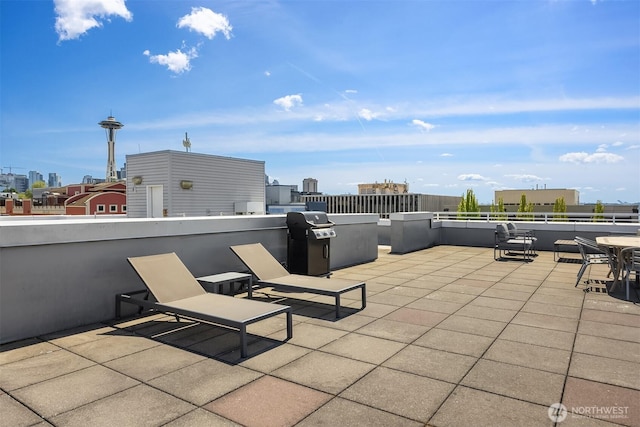 view of patio with a grill and a view of city