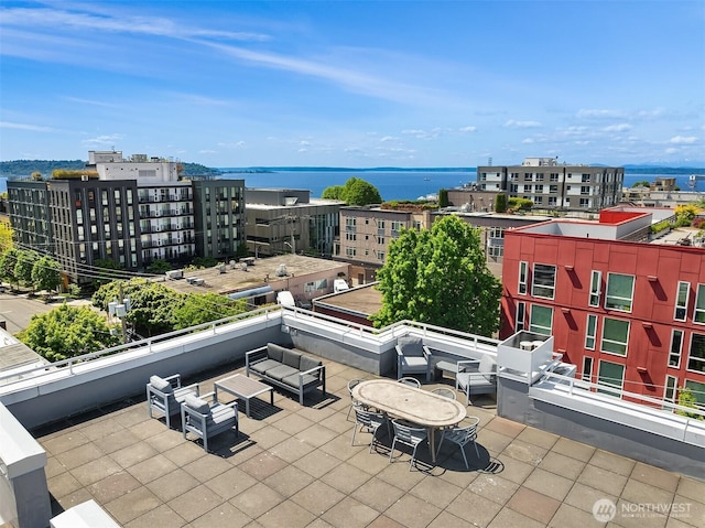 view of patio with an outdoor living space and a water view