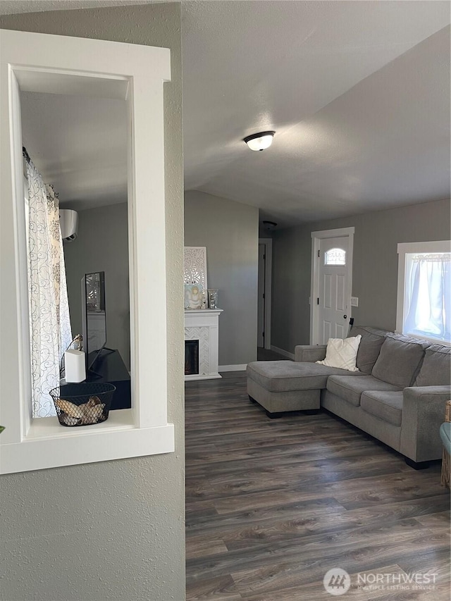 5600 Mt Solo Rd Unit 114, Longview, WA 98632 - living area with dark wood-style floors, a premium fireplace, a wall unit AC, and vaulted ceiling