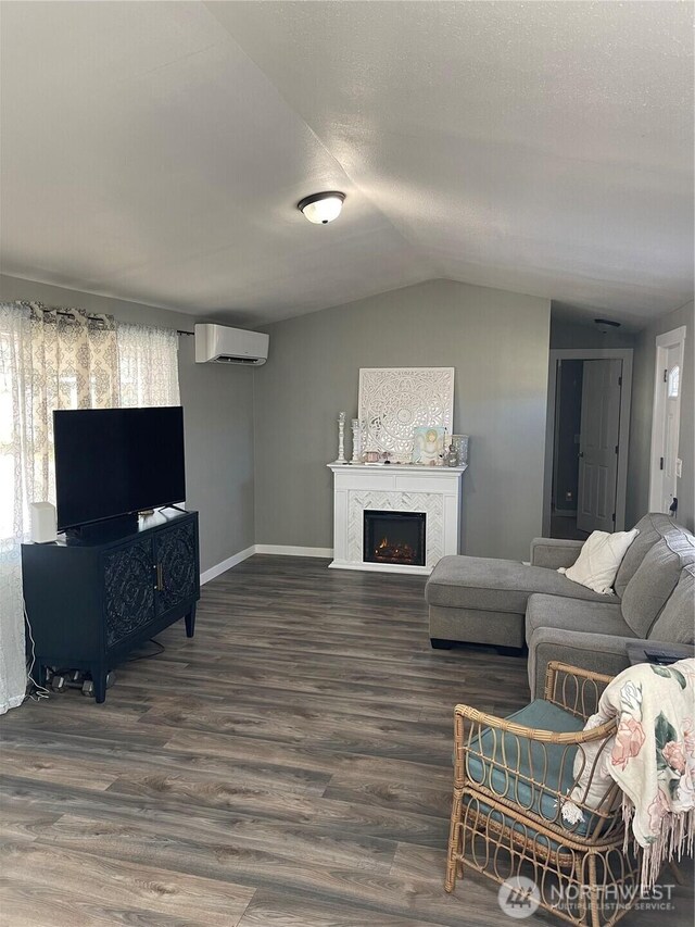 5600 Mt Solo Rd Unit 114, Longview, WA 98632 - living room featuring an AC wall unit, vaulted ceiling, wood finished floors, a fireplace, and plenty of natural light