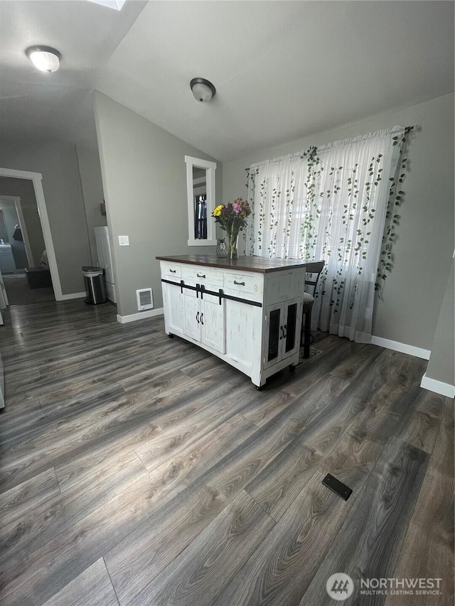 5600 Mt Solo Rd Unit 114, Longview, WA 98632 - kitchen featuring dark wood-style flooring, lofted ceiling, and white cabinetry