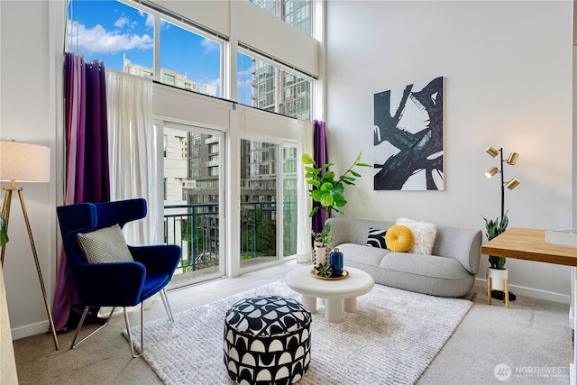 2415 2nd Ave Unit 743, Seattle, WA 98121 - sitting room featuring baseboards, carpet, and a towering ceiling