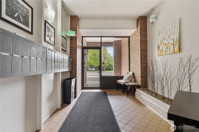 community lobby with brick wall and a textured ceiling