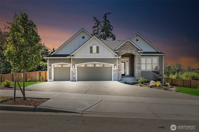 craftsman inspired home with board and batten siding, concrete driveway, and fence