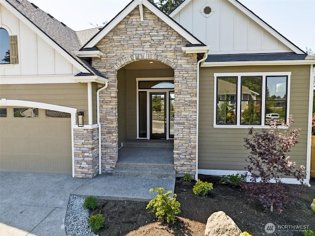 entrance to property featuring board and batten siding, stone siding, and a shingled roof
