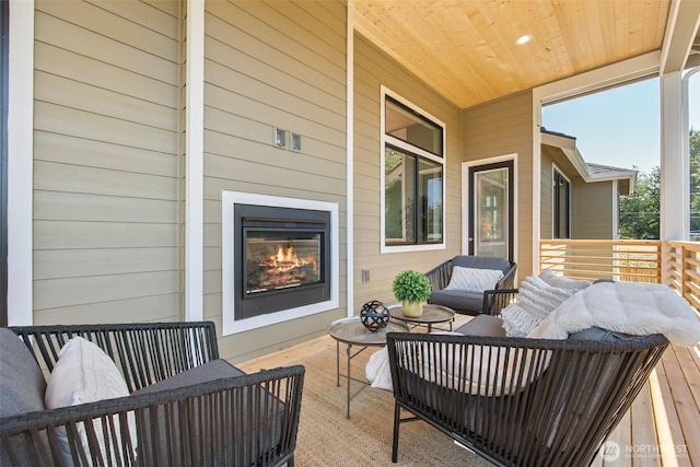 view of patio with an outdoor living space with a fireplace
