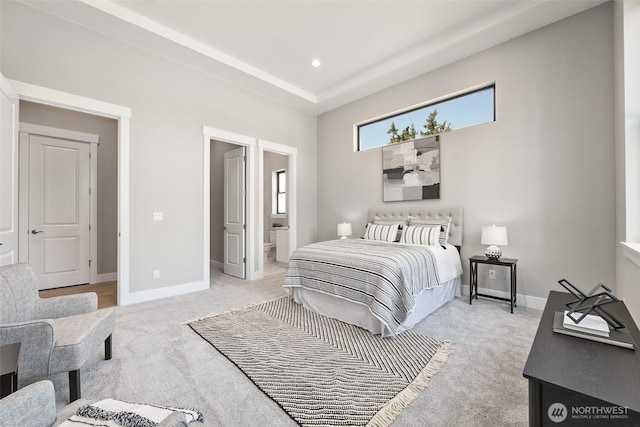 bedroom with light carpet, baseboards, ensuite bathroom, and recessed lighting