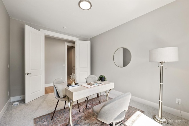 office with light carpet and baseboards