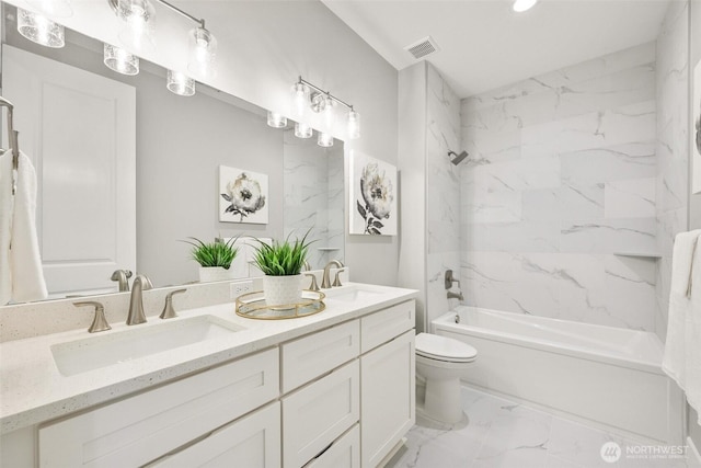 full bathroom with marble look tile flooring, toilet, bathtub / shower combination, double vanity, and recessed lighting