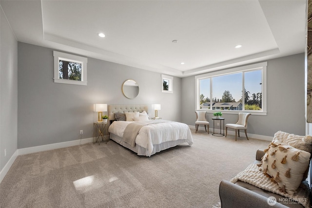 carpeted bedroom featuring a raised ceiling, recessed lighting, and baseboards