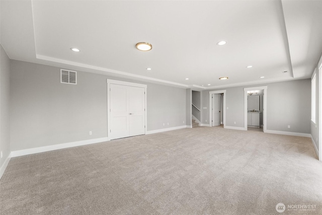 below grade area with stairway, recessed lighting, baseboards, and light colored carpet