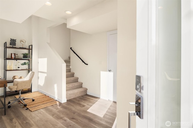 unfurnished office featuring wood finished floors, baseboards, and recessed lighting