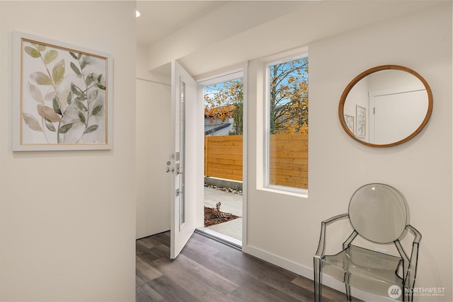 entryway with dark wood-style floors and baseboards