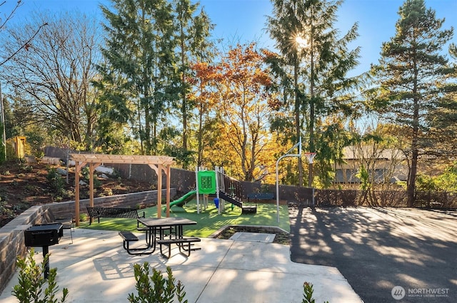 view of patio / terrace with a playground, a pergola, and fence