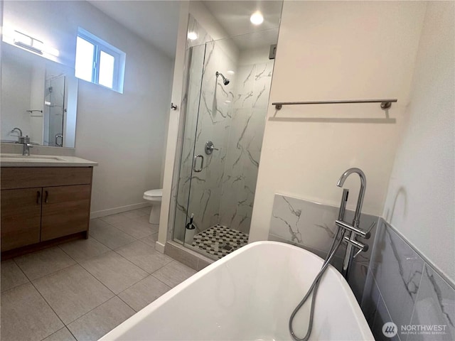 bathroom with a marble finish shower, vanity, a soaking tub, toilet, and tile patterned flooring