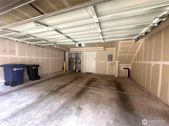 garage with electric panel, a garage door opener, and gas water heater