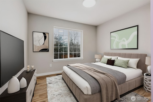 bedroom with light wood-style flooring and baseboards