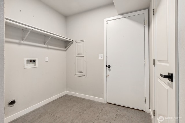laundry room featuring hookup for a washing machine, light tile patterned flooring, and baseboards