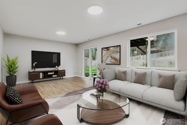 living room featuring wood finished floors, baseboards, and recessed lighting