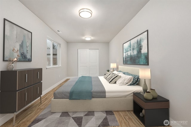 bedroom featuring wood finished floors, a closet, and baseboards