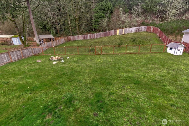 view of yard with a storage shed and an outbuilding