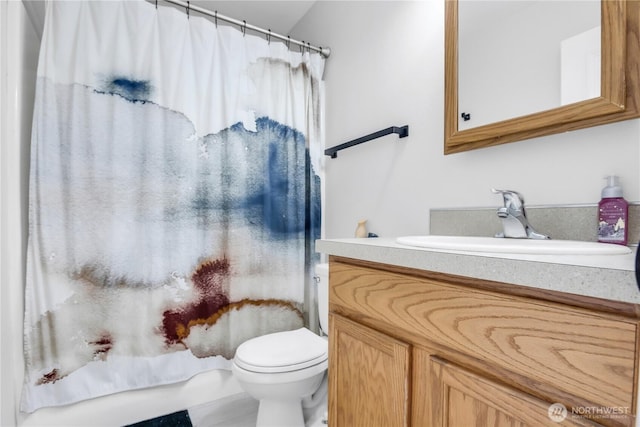 full bathroom with toilet and vanity