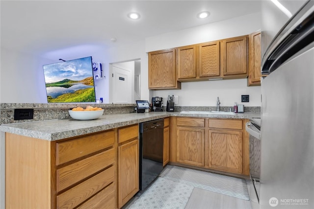 kitchen featuring refrigerator, a sink, black dishwasher, a peninsula, and range