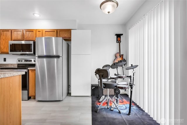 kitchen with appliances with stainless steel finishes and brown cabinets