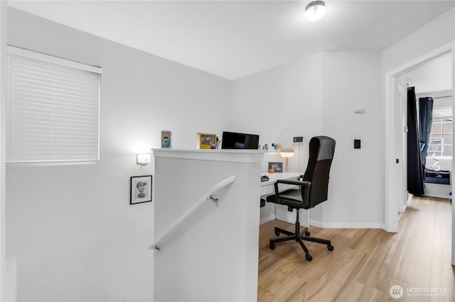 office space with light wood-style flooring and baseboards