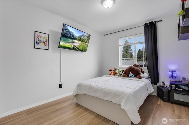 bedroom featuring light wood-style flooring and baseboards