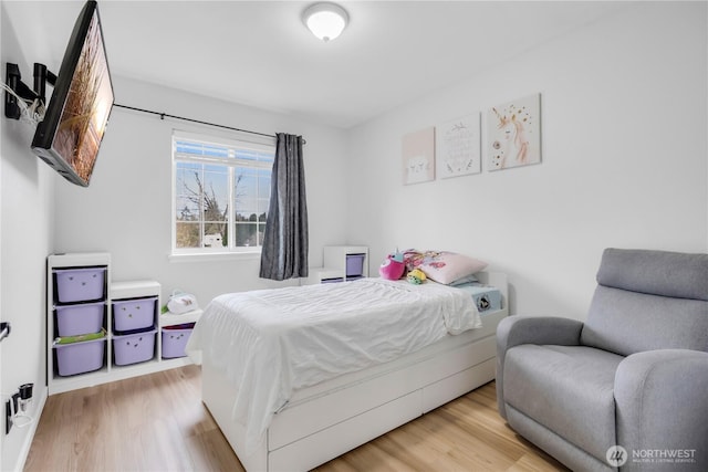 bedroom with wood finished floors