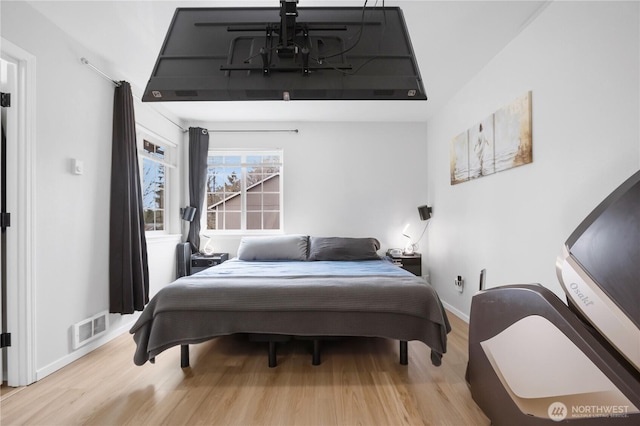 bedroom featuring wood finished floors and baseboards