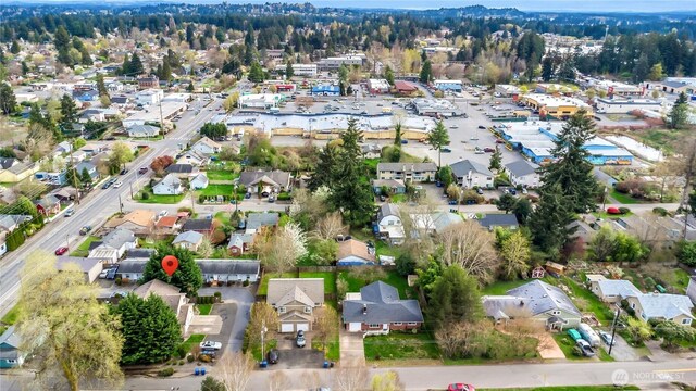 aerial view of property and surrounding area with nearby suburban area