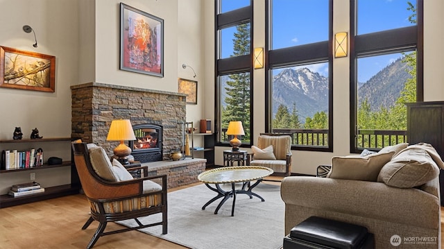 510 Dempsey Rd, Leavenworth, WA 98826 - living area featuring a high ceiling, wood finished floors, a fireplace, and a mountain view