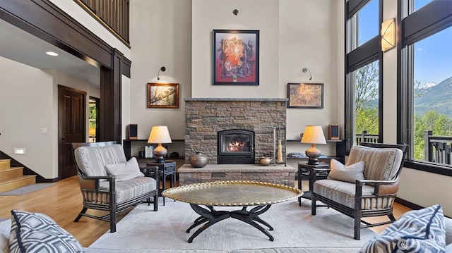 510 Dempsey Rd, Leavenworth, WA 98826 - living room with a towering ceiling, light wood-style flooring, plenty of natural light, and a stone fireplace