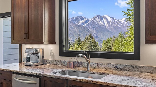 510 Dempsey Rd, Leavenworth, WA 98826 - kitchen with a sink, dark brown cabinetry, a mountain view, and light stone countertops