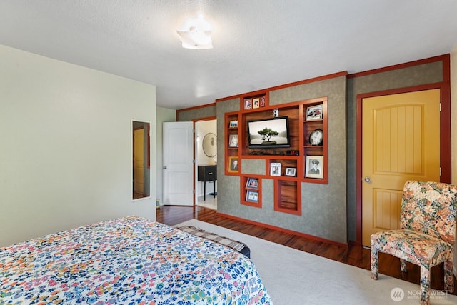 bedroom with wood finished floors, baseboards, and ornamental molding