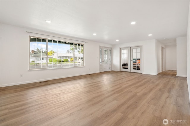 133 Bradley St, Walla Walla, WA 99362 - unfurnished living room featuring recessed lighting, baseboards, light wood finished floors, and french doors