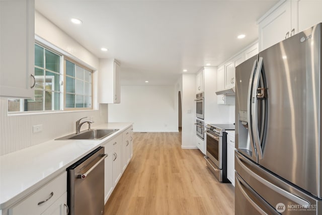 133 Bradley St, Walla Walla, WA 99362 - kitchen with stainless steel appliances, a sink, light wood-type flooring, white cabinetry, and recessed lighting