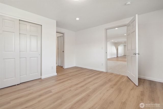 133 Bradley St, Walla Walla, WA 99362 - unfurnished bedroom with arched walkways, light wood-type flooring, recessed lighting, and baseboards