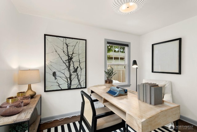 home office featuring baseboards and wood finished floors