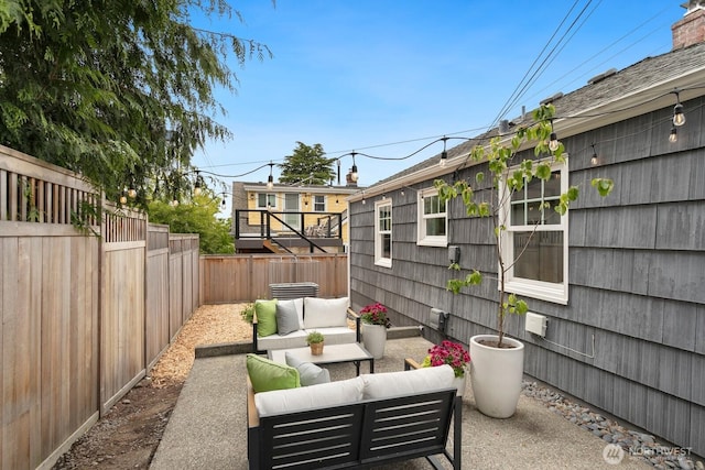 view of patio with outdoor lounge area and a fenced backyard