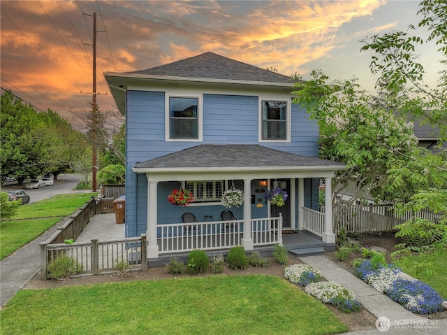 traditional style home featuring a porch and a shingled roof