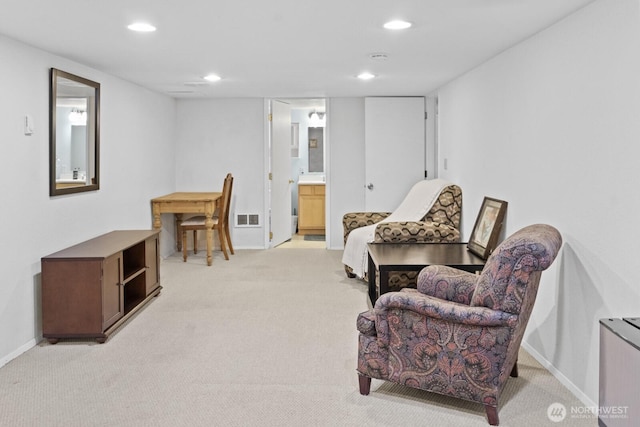 sitting room with light carpet, recessed lighting, and baseboards