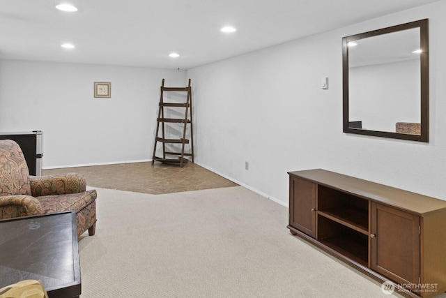 living area featuring recessed lighting, light carpet, and baseboards