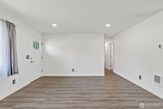 entryway featuring wood finished floors, recessed lighting, and baseboards